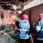 Firefighters are trying to extinguishing a blaze triggered by a cylinder explosion in Liaquat Colony