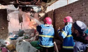 Firefighters are trying to extinguishing a blaze triggered by a cylinder explosion in Liaquat Colony
