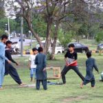 Children are playing 'bandar killa" a Punjabi traditional game in the green belt in the federal capital