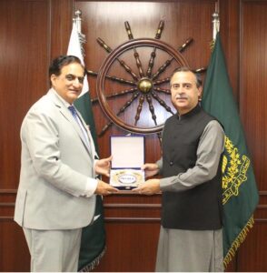 Vice Admiral Ahmed Saeed HI(M) (Retd), President of the National Institute of Maritime Affairs (NIMA) presenting a shield to Federal Minister for Maritime Affairs, Muhammad Junaid Anwar Chaudhry