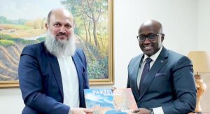 Federal Minister for Commerce Jam Kamal Khan presents a tourism book on Pakistan to Rwandan Foreign Minister Ambassador Olivier J.P. Nduhungirehe, inviting him to explore the country’s scenic northern regions.