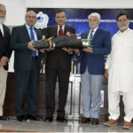 Rector UOL Muhammad Ashraf and Rector Lahore Garrison General Haider present bouquets of flowers to the participants participating in the regional round of the Pakistan Universities Debating Championship held at the Quaid-e-Azam Campus of the Institute of Energy and Environmental Engineering, Punjab University at the end of the ceremony