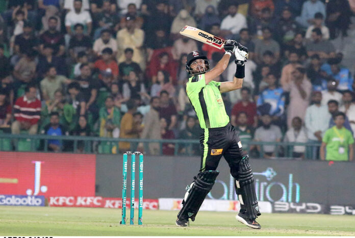 Lahore Qalanders batter Sikander Raza playing shot during the Pakistan Super League PSL-X T20 cricket match between Lahore Qalanders and Peshawar Zalmi at the Gaddafi Cricket Stadium