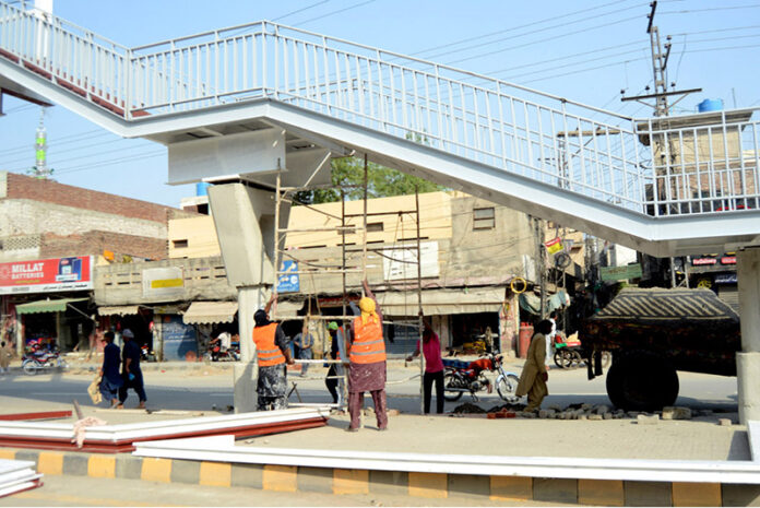 Workers are busy constructing a new pedestrian bridge on Walton Road