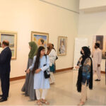 Visitors view the "A Moment in Time" painting exhibition, at the National Art Gallery, organized by ForArtSake and the Pakistan National Council of the Arts (PNCA)