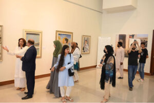Visitors view the "A Moment in Time" painting exhibition, at the National Art Gallery, organized by ForArtSake and the Pakistan National Council of the Arts (PNCA)