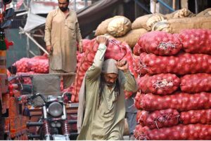 Labourers unloading sacks of onion from a delivery truck at the Islamabad Fruit and Vegetables market as the world celebrates International Labour Day. May 1st, International Workers' Day, commemorates the historic struggles of working people worldwide. In 1884, the Federation of Organized Trades and Labour Unions passed a resolution declaring that eight hours would constitute a legal day's work, effective from May 1, 1886