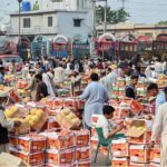 Vendors displaying melons for bidding at the fruit market in the Federal Capital