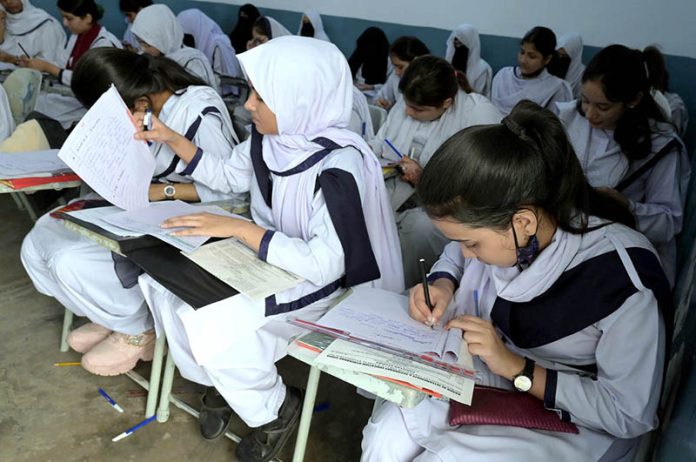 Students solving question paper during annual examination of HSC (Part-II) 2025 at Hayat Girls Collage