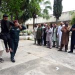 Rescue workers conducting emergency response training at Radio Pakistan, equipping participants with essential life-saving skills and techniques through practical demonstration