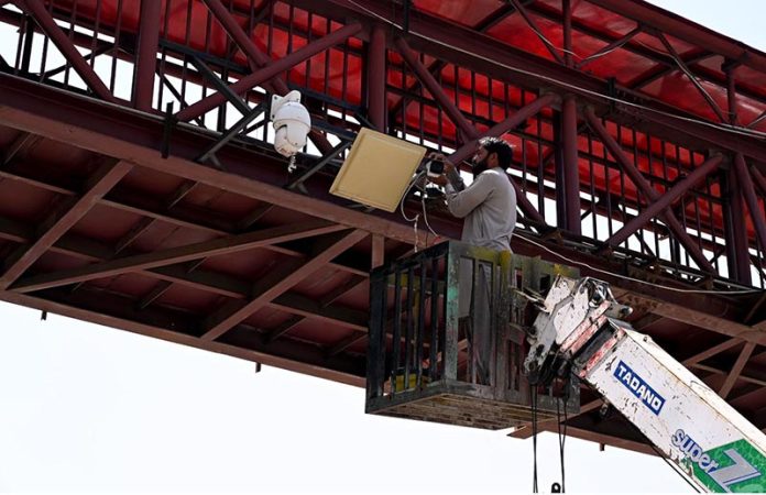 Worker busy repairing CCTV cameras at Faisal Avenue