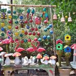 A vendor displays clay made pots and crafted artificial bird nests for garden décor to attract customers at H-9 Nursery