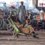 Tired laborer takes a nap after a hard day in Islamabad’s vegetable market