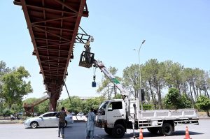 Worker busy repairing CCTV cameras at Faisal Avenue