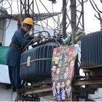A WAPDA staffer busy in repairing power transformer at Jhumra Road