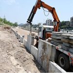 Laborer’s busy making roadside boundary wall at the site of under construction 10th Avenue during development work in Federal Capital
