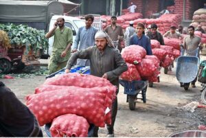 Labourers unloading sacks of onion from a delivery truck at the Islamabad Fruit and Vegetables market as the world celebrates International Labour Day. May 1st, International Workers' Day, commemorates the historic struggles of working people worldwide. In 1884, the Federation of Organized Trades and Labour Unions passed a resolution declaring that eight hours would constitute a legal day's work, effective from May 1, 1886