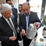 Federal Minister for National Food Security and Research, Rana Tanveer Hussain inspects an olive products stall during the workshop on "Innovating the Olive Value Chain: Startups, Entrepreneurship & Opportunities", organized under Phase-II of the Promotion of Olive Cultivation on Commercial Scale project by the Ministry of National Food Security & Research at SZABIST