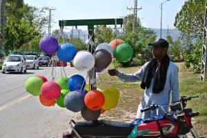 A vendor displaying colorful lights on his motorcycle to attract the customers in Federal Capital.