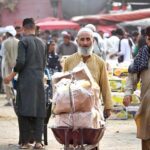 An elderly labourer pushing handcart loaded with luggage of a person at the Islamabad Fruit and Vegetables market as the world celebrates International Labour Day. May 1st, International Workers' Day, commemorates the historic struggles of working people worldwide. In 1884, the Federation of Organized Trades and Labour Unions passed a resolution declaring that eight hours would constitute a legal day's work, effective from May 1, 1886