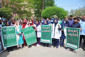 Doctors and paramedical staff of Nishtar Medical University hold a rally carrying National flags and banners to express solidarity with the Pakistan Army, paying tribute to its role in defending the nation and ensuring peace