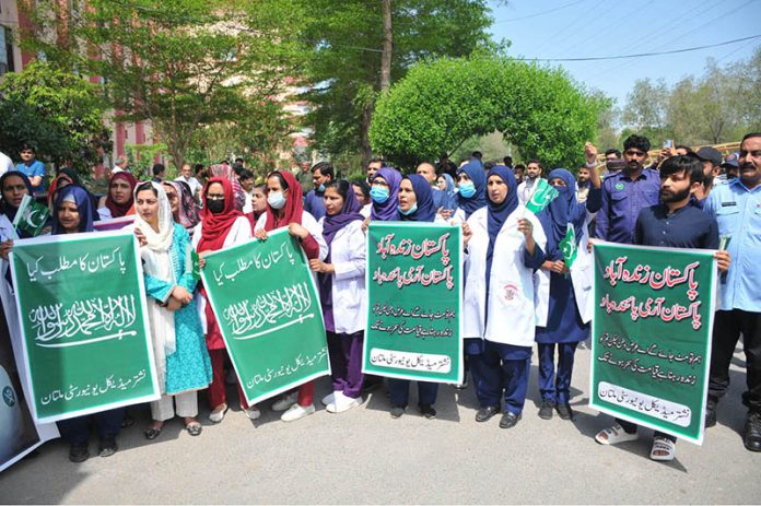Doctors and paramedical staff of Nishtar Medical University hold a rally carrying National flags and banners to express solidarity with the Pakistan Army, paying tribute to its role in defending the nation and ensuring peace