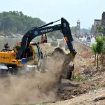 Irrigation staffer busy in Desiltation of Phulile Canal with help of heavy machine
