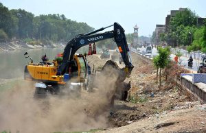 Irrigation staffer busy in Desiltation of Phulile Canal with help of heavy machine