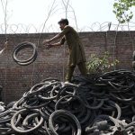 Laborers busy in their work at scrap tires gudon at Ring road
