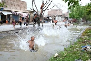Youngster jumping and bathing in canal at Fazil Town to get some relief from scorching hot weather in the city.
