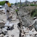 Labourers busy in their work at the site of under construction at Lehtrar Road