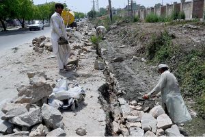 Labourers busy in their work at the site of under construction at Lehtrar Road