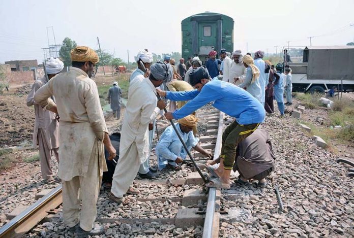 Workers of Pakistan Railways are busy repairing the railway track after the Shalimar Express passenger train collided with a bricks-loaded tractor trolley near RB-142 Choti Ghartal, Sahianwala Interchange near Chak Jhumra