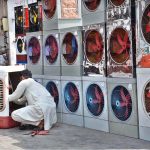 A shopkeeper prepares room coolers for sale at his workplace, as temperatures is increasing day by day in the city