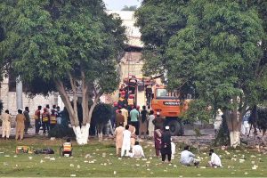 Rescue workers carry out search and rescue operations at the Government Health and Educational Complex in Muridke, about 30 kilometers from Lahore, following Indian airstrikes