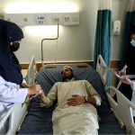 Nursing staff attend to a patient as part of their duties on International Nurses Day at Lady Reading Hospital