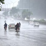 Vehicles on the way at Islamabad Expressway during rain that experienced the Federal Capital