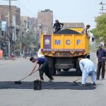 Labourers engaged in road repair work to ensure smooth traffic flow, as part of ongoing development projects in the city