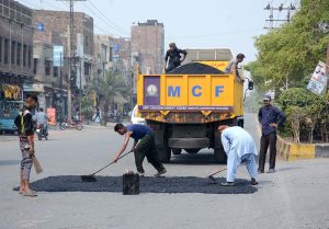 Labourers engaged in road repair work to ensure smooth traffic flow, as part of ongoing development projects in the city