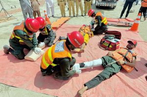 Rescue 1122 personnel perform life-saving drills during a pre flood mock exercise near the Chenab River, practicing CPR, bandaging, and emergency care to ensure swift response during potential disasters.