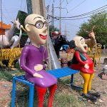 Fiber statues of famous cartoon characters Motu Patlu displayed for sale on the roadside in the federal capital