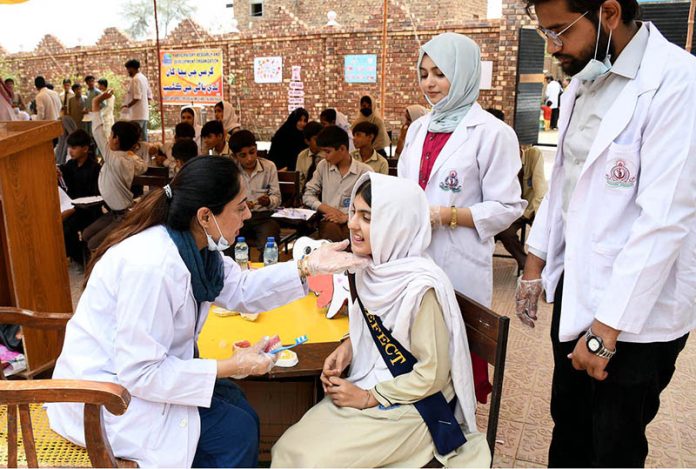 Doctor of LUMHS providing health awareness to students of Govt. Sachal Education Academy during health care medical camp organized by Liaquat University of Medical & Health Sciences Jamshoro