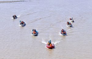 Rescue 1122 personnel perform life-saving drills during a pre flood mock exercise near the Chenab River, practicing CPR, bandaging, and emergency care to ensure swift response during potential disasters.