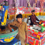 A vendor is busy preparing traditional summer drink (Ghota) for the customers at his roadside setup