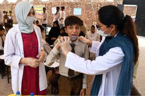 Doctor of LUMHS providing health awareness to students of Govt. Sachal Education Academy during health care medical camp organized by Liaquat University of Medical & Health Sciences Jamshoro