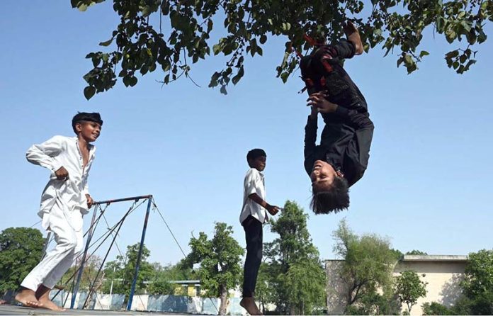 Children enjoy jumping on a trampoline to beat boredom in G7 sector of the federal capital
