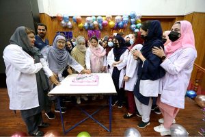 Nursing staff cut a cake to celebrate the International Nurses Day celebrations at Lady Reading Hospital