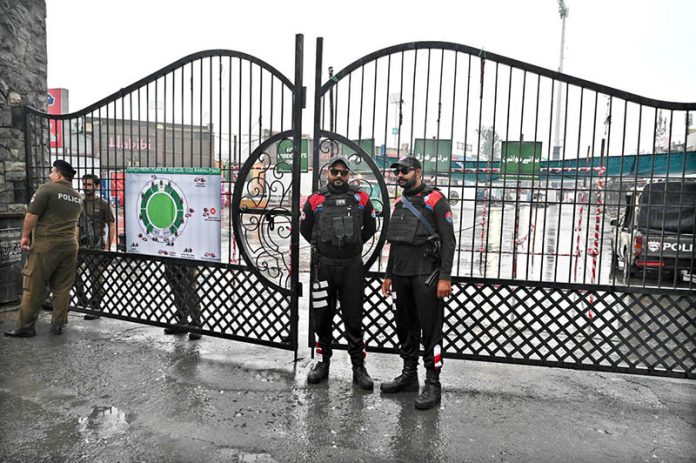 Security personnel stands alert in front of Food Street gate and cordon off area after Pakistan shot down Indian drone