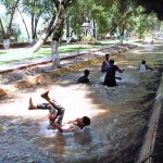 Children and young people are taking a dip in the canal water to escape the intense heat