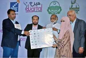 Provincial Minister for Health and Population Khawaja Imran Nazeer is distributing desktop computers during a ceremony at local Hotel